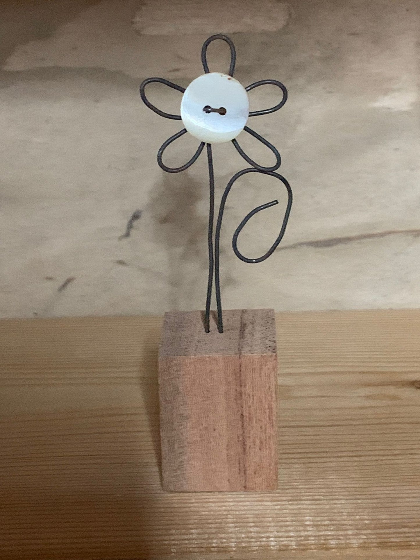 Wire flower in a wooden block